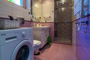 a bathroom with a washing machine and a shower at Cyrhla przy szlaku in Zakopane +116 photos