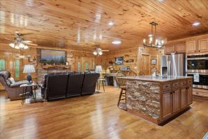 a large kitchen with wooden walls and wooden floors at Chasing Cubs Cabin By Beyond Expectations in Sevierville