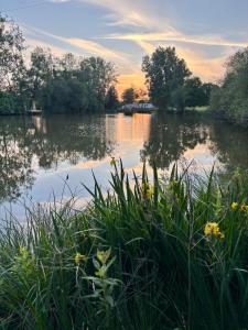 a view of a river at sunset at Les Rives De Bel Air - Hébergements - Camping - Caravaning in Saint-Siméon