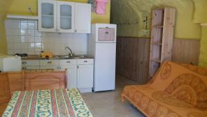 a small kitchen with a refrigerator and a sink at Gîte #3, 3 Pers, Domaine De Ribiere in Grospierres