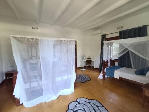 Postel nebo postele na pokoji v ubytování Kivulini