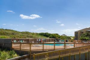 a resort with a swimming pool and a building at Quite Right in Nags Head