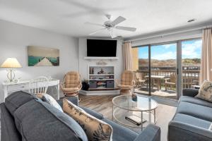 a living room with a couch and a table at Quite Right in Nags Head