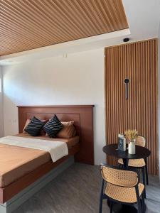 a bedroom with a bed and a table and chairs at CASA KM Beach Pool Access in Dauis +32 photos
