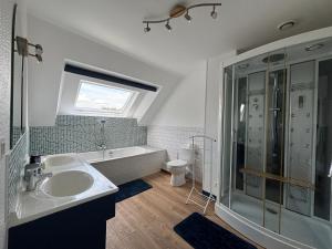 a bathroom with a sink and a tub and a shower at Chambres d 'hôtes Le Grand Pré in Bettembos +36 photos