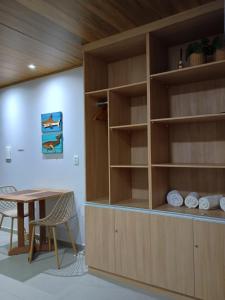 a room with a wooden book shelf and a table at FLAT 231 Shopping Amarração in Luis Correia
