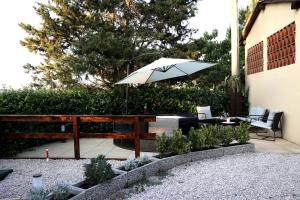 a patio with a table and an umbrella at Tognazzi Casa Vacanze - Dimora Bunny e Danny in Villa del Monte