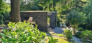 a brick building in a garden with plants at 1Step2AllNature Tinyhouse in Wuppertal +102 photos