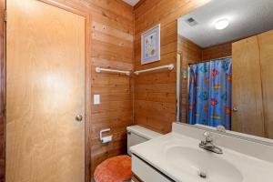 a bathroom with a toilet and a sink at RoSea Retreat in Nags Head +46 photos
