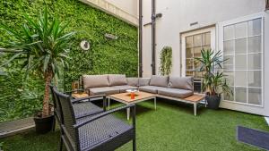 a patio with a couch and a table at Luxury Interior Designed 3 Bedroom Apartment in Central London in London