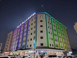 a large building with lights on top of it at Al Rayan Hotel in Ajman