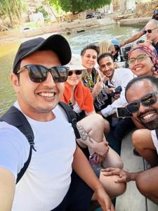 un grupo de personas sentadas en la parte trasera de un barco en INTERNATIONAL HOSTEl, en Mascate