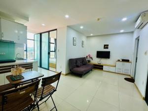 a living room with a table and a couch at Infinity Sea View Apartment in Nha Trang
