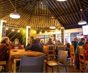 a group of people sitting at a table in a restaurant at Alpamayo Casa Hotel - Restaurante in Yungay