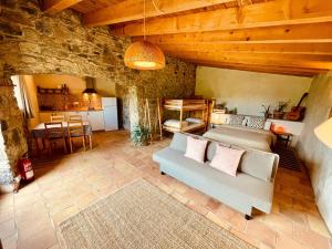 a living room with a bed and a table at Mas rural El Negre in Ogassa