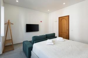 ファロにあるCasa São Francisco Old Town Faroのベッドルーム(緑色のベッド1台、テレビ付)