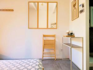 a bedroom with a bed and a mirror on the wall at Allegria Nîmes in Nîmes