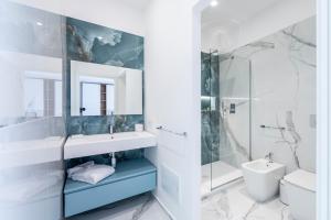 a bathroom with a sink and a toilet and a shower at Alberti Apartments in Trapani