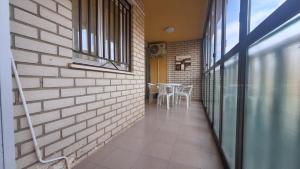 ein Flur mit einer Ziegelwand und einem Tisch in der Unterkunft MISTRAL 2 Habitaciones in Oropesa del Mar