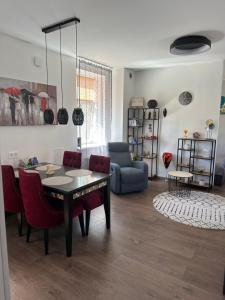 a living room with a table and chairs and a couch at Studija tipa dzīvoklis blakus jūrai in Liepāja +10 photos