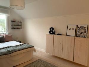 a bedroom with a bed and a wooden cabinet at Family-Friendly House with Garden & Terrace by the Sea in Bovallstrand