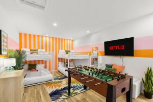 a living room with a foosball table in the middle at Resort Style Backyard Pool Sport Court Putt Putt in Seminole