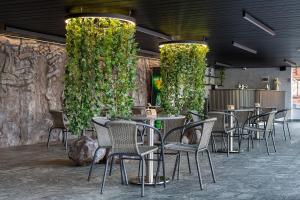 a group of chairs and tables in a restaurant at Chalet Podgorie Spa&Resort in Bukovel
