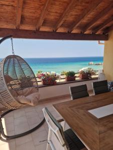a room with a hammock and a view of the ocean at Corfu Glyfada Beach Apartment 91 in Glyfada