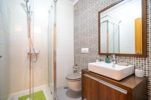 a bathroom with a sink and a toilet and a mirror at BeGuest City Center in Olhão in Olhão +9 photos