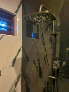a shower in a bathroom with a glass wall at BOB Forest Stay in Batheri +27 photos