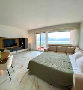 a large bedroom with a large bed and a television at The Grand Vista - Lake View & Parking in Lugano