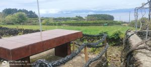 a wooden table sitting on top of a stone wall at Adega do Xano in Cais do Galego +2 photos