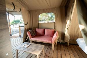 a couch and a table in a tent at Badoca Safari Glamping Experience in Azelhal