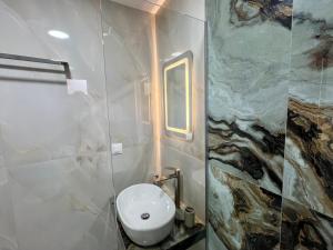 a bathroom with a toilet and a sink at Salt & Sea in Sarti
