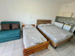 two beds and a couch in a room at Salt & Sea in Sarti
