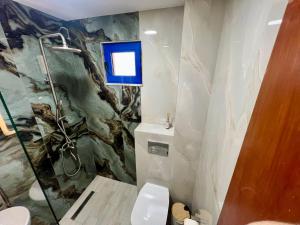 a bathroom with a shower and a toilet in it at Salt & Sea in Sarti +5 photos