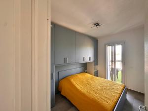 a bedroom with a bed with a yellow blanket at Riflessi D'aurora in Castelsardo +43 photos