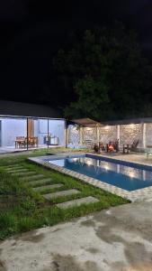 a swimming pool at night with a table and a tent at redHome in Gabala