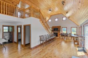 a large living room with a wooden ceiling and a staircase at Near Cavendish Beach-2 in Stanley Bridge