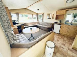 an interior view of an rv with a table and a kitchen at 2 Bedroom Caravan GW39, Thorness Bay, Isle of Wight, Dog Friendly in Porchfield