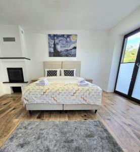 a bedroom with a large bed and a fireplace at Klimatyczny Dom na Mazurach przy jeziorze in Sędańsk