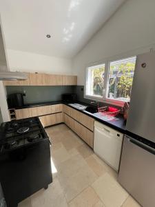 a kitchen with a stove and a sink at Villa les Tamaris in Gignac +5 photos