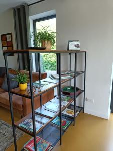 a book shelf with books and plants on it at HYTTA in Arendonk