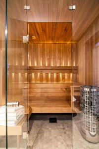 a sauna with wooden walls and a glass wall at New lodge at seaside, near Henningsvær Lofoten in Kleppstad +22 photos
