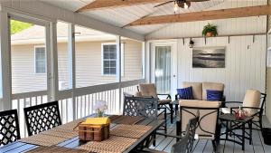 a screened porch with a table and chairs at 208 Pontaxit Avenue, North Cape May in North Cape May