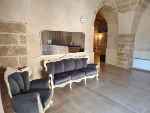 a living room with two chairs and a couch at Borgo Don Ciccio Dimora Storica in Felline +76 photos