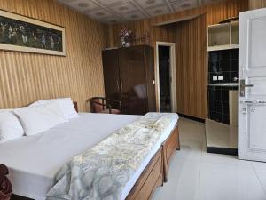 a bedroom with a large bed in a room at Maskan Guest House in Murree