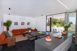 a living room with a couch and a table at Bridge House 201 - 3BR Penthouse in Limassol