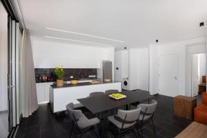 a kitchen and dining room with a table and chairs at Bridge House 201 - 3BR Penthouse in Limassol