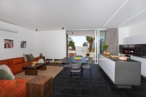 a living room with a couch and a table at Bridge House 201 - 3BR Penthouse in Limassol +40 photos
